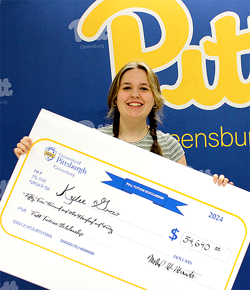 Kylee Grew holds check for full-tuition scholarship to Pitt-Greensburg