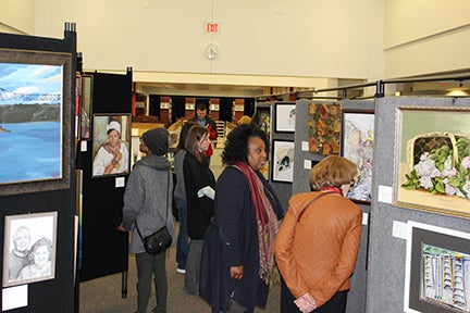 Art enthusiasts browsing art show