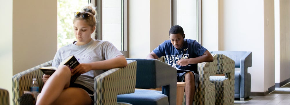 Two students seated in study space