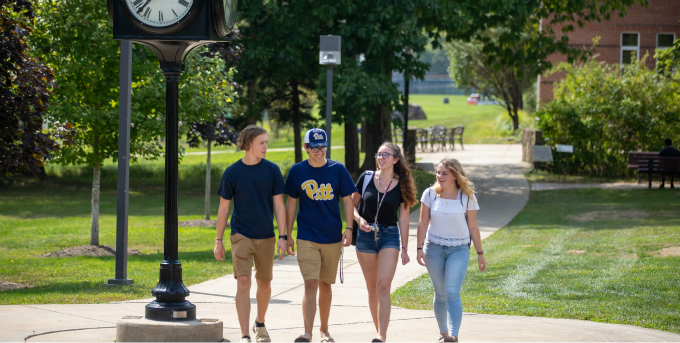 Four students walking on campus