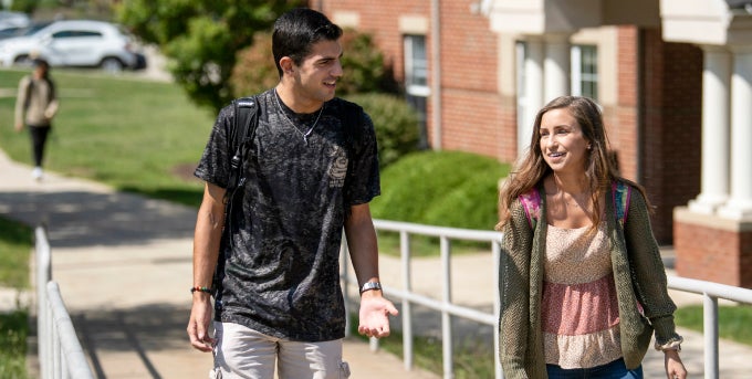 Two students walking outside on campus