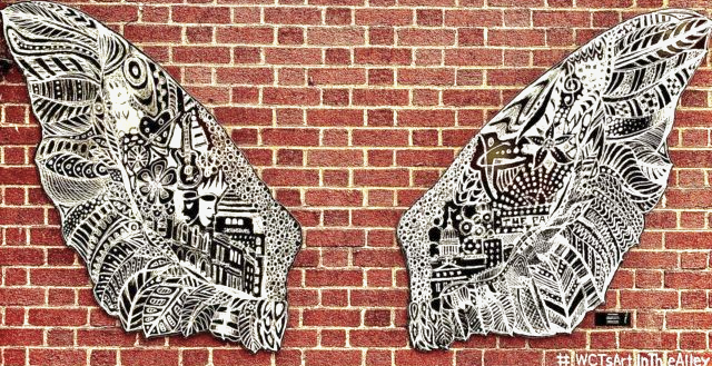 Wings art exhibit on brick wall in Greensburg, PA