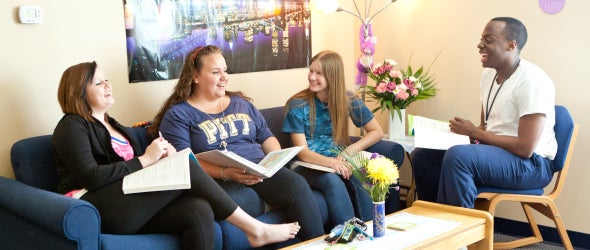 Students laughing in Westmoreland Hall living room