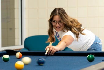 Student playing pool