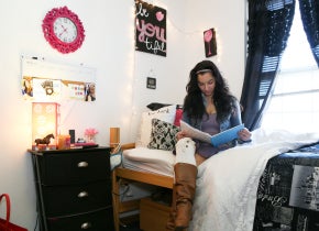 Student studying in Academic Village bedroom