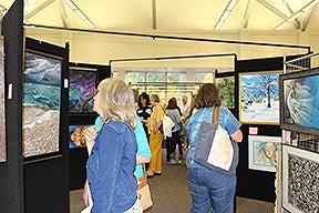 Visitors viewing the artwork at the 2019 Art Show @ Pitt-Greensburg