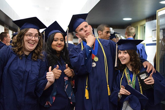 Four graduates posing for camera