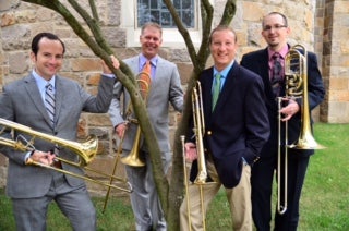 Four members of Pittsburgh Trombone Project holding trombones
