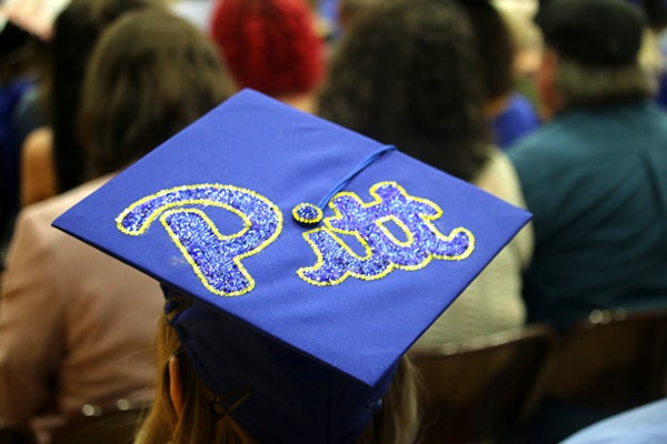 Graduation mortar board decorated with "Pitt" in glitter
