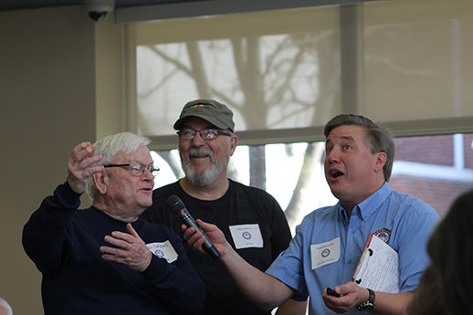Three individuals speaking at Veterans Breakfast Club event
