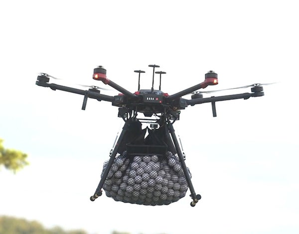 Drone carrying golf balls in a net