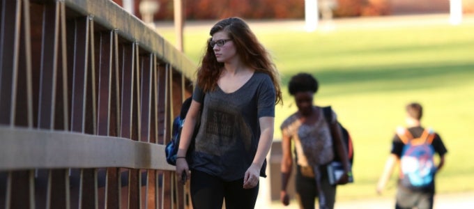 Student walking on bridge