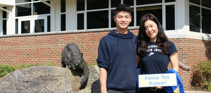 Student and parent posing with Bobcat statue