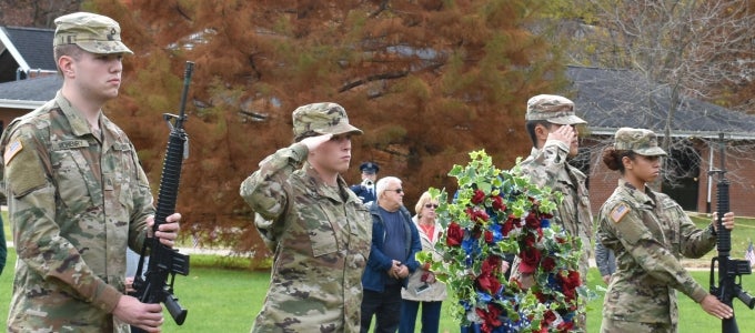Veterans saluting at ceremony