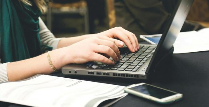 person typing on a laptop