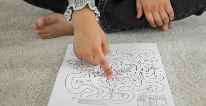 child pointing at a piece of paper