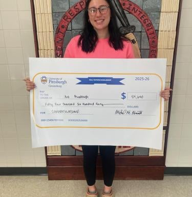 Ava Brumbaugh with her scholarship check