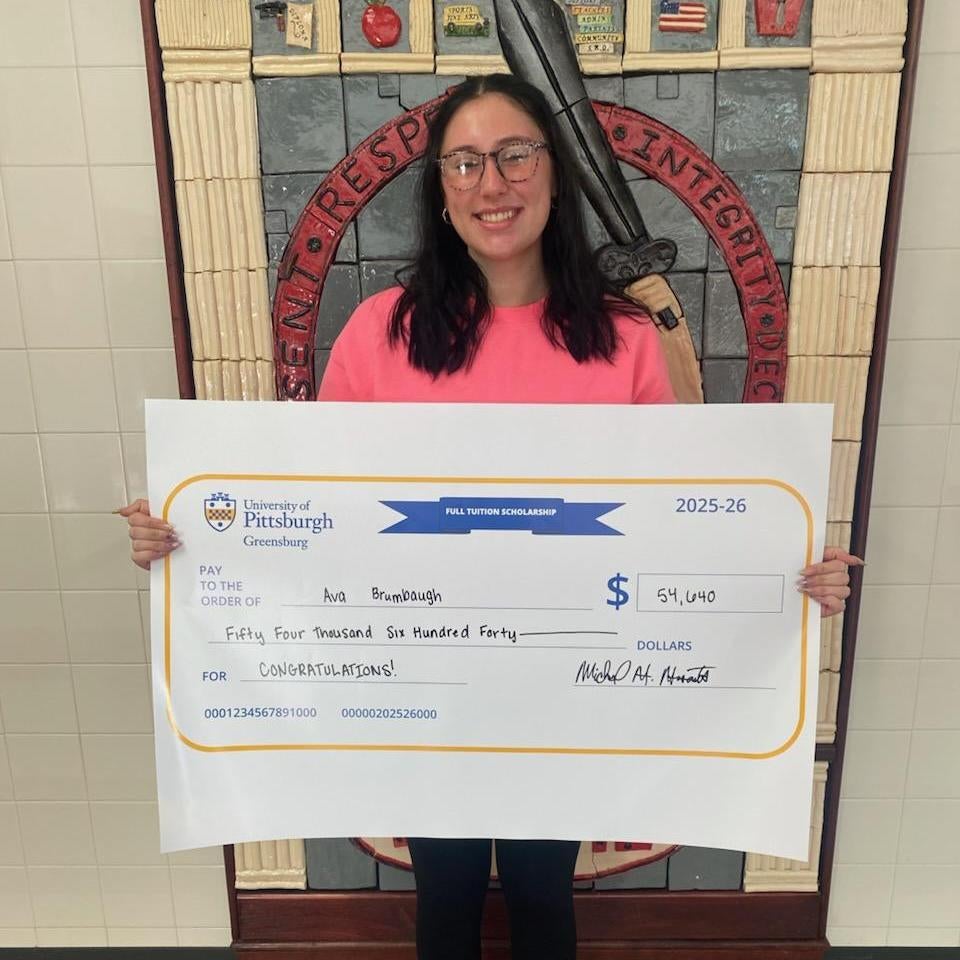 Ava Brumbaugh with her scholarship check