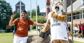 Student and Bruiser Bobcat mascot posing
