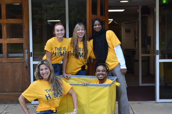 Students moving into dorm rooms and Pitt-Greensburg staff helping.