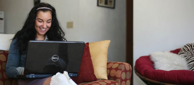 Student using laptop on couch